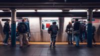 A group of people waiting to get onto a subway in New York City